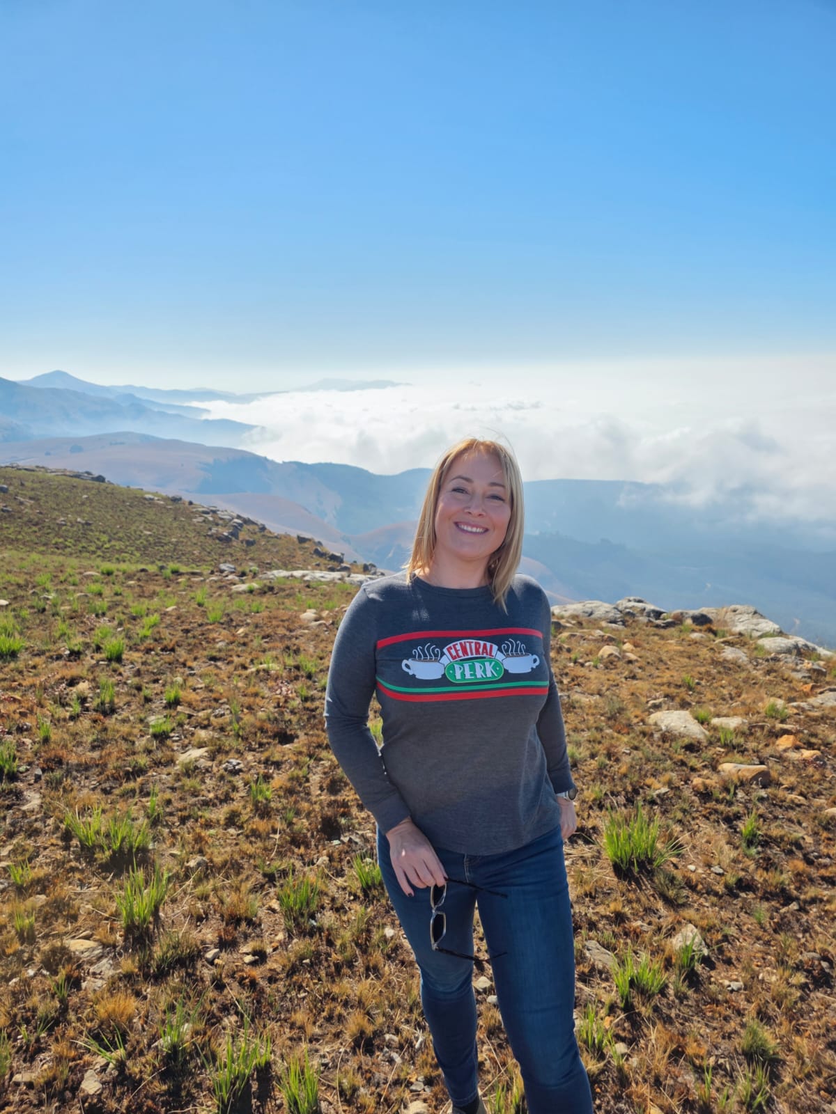 Charlene Coetzee, founder of Terra PR, standing on a mountain above the clouds near Lydenburg
